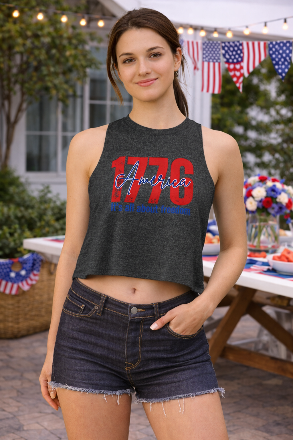 Woman wearing a crop top with '1776 America' text in an outdoor setting with American flags.