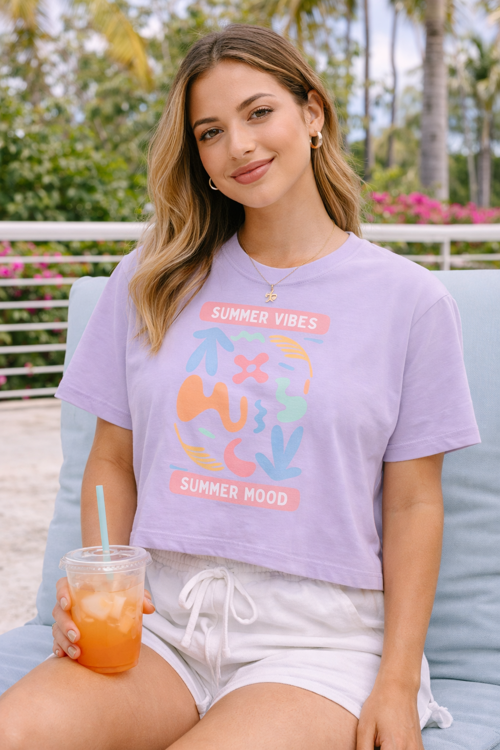 Woman wearing a purple 'Summer Vibes' t-shirt sitting outdoors.